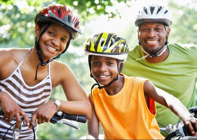 Family of Three Riding Bikes